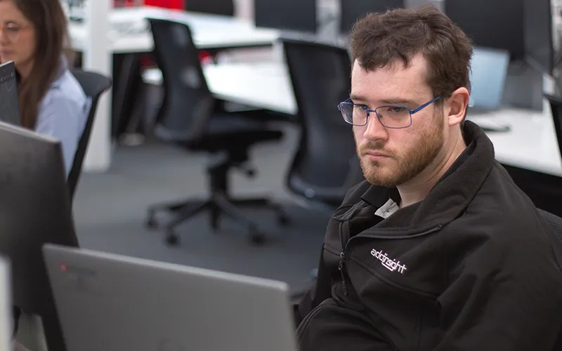 Luke working
at the desk at Addinsight.