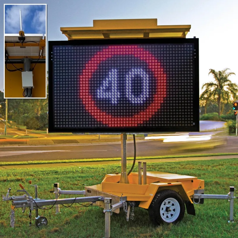 J1-LED portable VMS trailer displaying a 40 km/h speed limit sign, with an inset close-up of the Wireless Locator antenna and enclosure fitted to the trailer